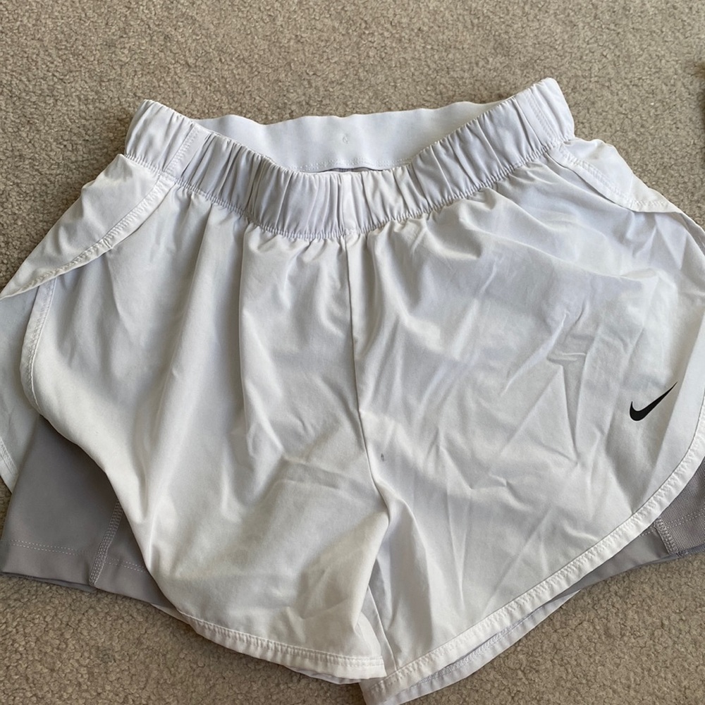 White Nike shorts with gray attached spandex w pockets.